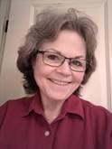 Smiling woman with glasses and gray hair
