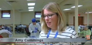 Woman with glasses speaking in community hall