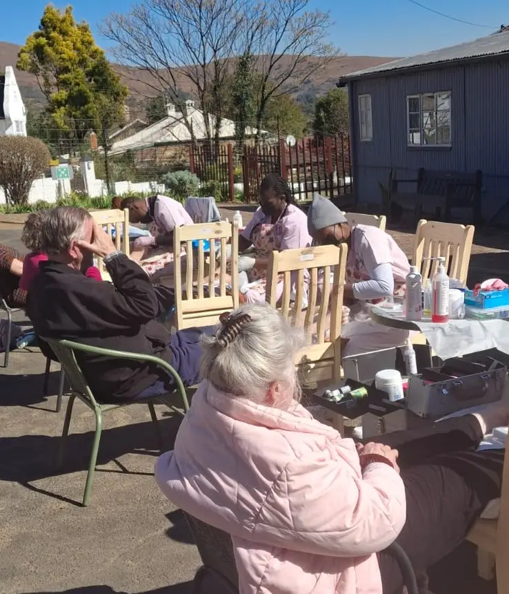 Arinda's team providing care to elderly residents in an outdoor program
